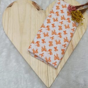 Tecido tricoline estampado laços poá laranja claro fundo branco
